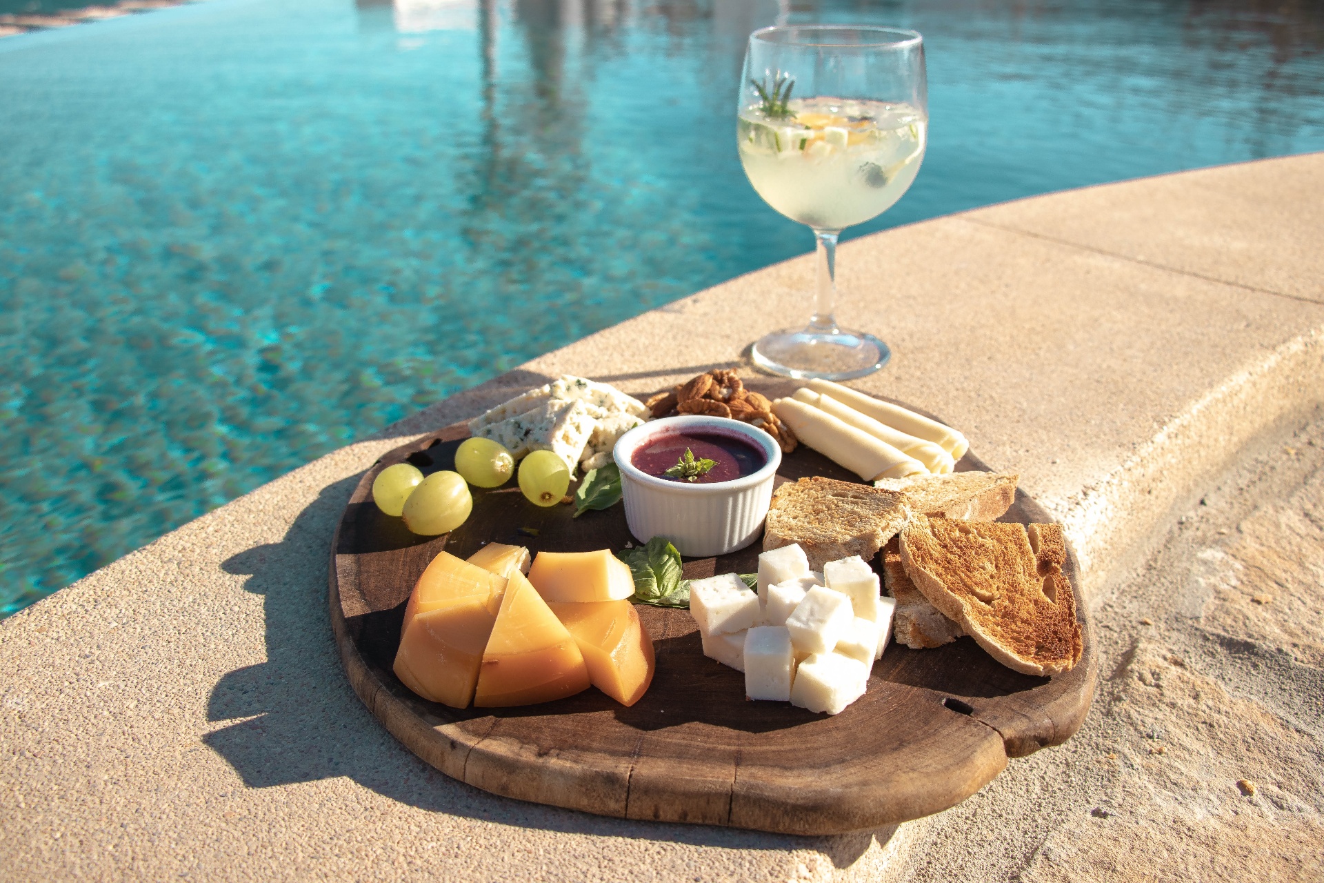 Poolside cheese board and wine