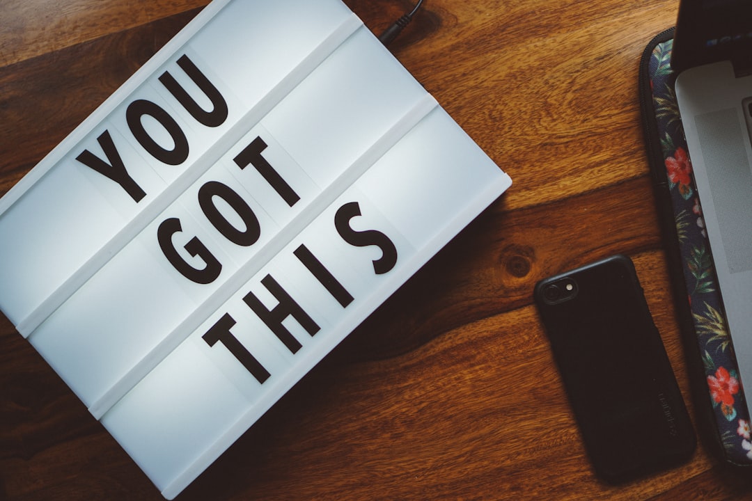 A light box sign that reads 'You Got This' on a wooden desk